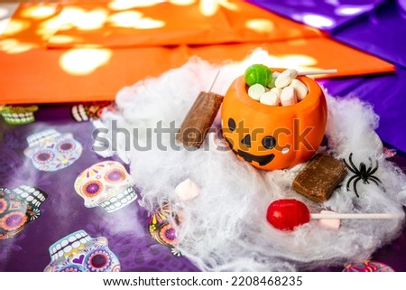 halloween image, pumpkin, candy and spider webs.
