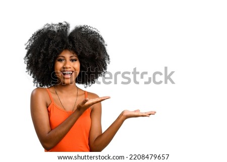 young woman points with her hands to the left side, a space for her product or message, person, advertising concept