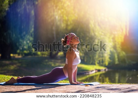 Young woman doing yoga in morning park  Royalty-Free Stock Photo #220848235