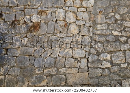 Ancient stone wall in the architecture of the old city. Background or backdrop