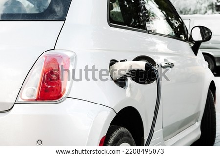 Electric car at the charging station. Ecology. Eco-friendly transport Royalty-Free Stock Photo #2208495073