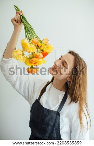 Portrait of a woman holding a bouquet of flowers - stock photo