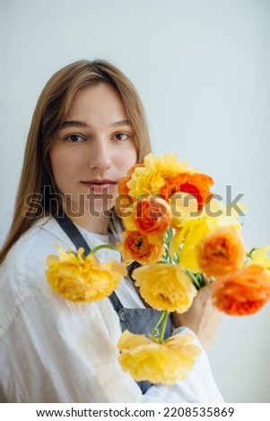 Portrait of a woman holding a bouquet of flowers - stock photo