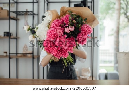 Owner working at flower shop - stock photo

