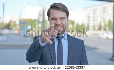 Businessman Pointing at the Camera Outdoor