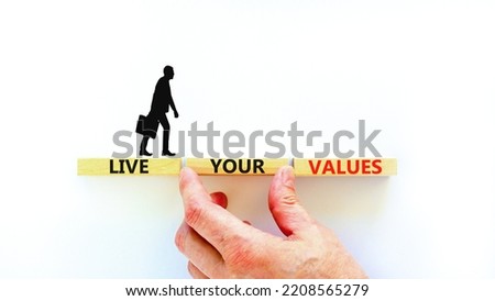 Live your values symbol. Concept words Live your values on wooden blocks. Businessman hand. Beautiful white table white background. Business, psychological and live your values concept. Copy space.