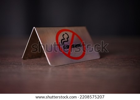 No smoking sign on wooden cafe, bar, restaurant table. High quality photo