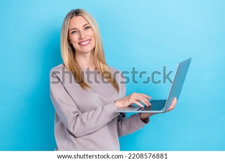 Photo of cheerful lady office worker wear trendy sweater buy new cool device gadget low price shop isolated on blue color background