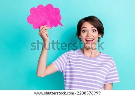 Photo of gorgeous impressed nice woman with bob hairdo dressed striped t-shirt hold pink cloud isolated on turquoise color background