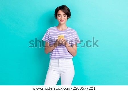 Photo of pretty cute lovely lady hold telephone gadget post repost instagram twitter facebook isolated on aquamarine color background