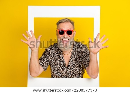 Photo portrait of nice grandpa raise palms hello instant photo frame wear trendy leopard print garment isolated on yellow color background