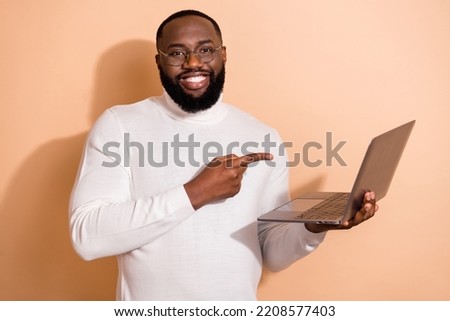 Photo of positive guy promoter use netbook demonstrate web promo ads ecommerce eshop isolated pastel color background