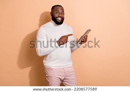 Photo of positive smart guy worker use tablet gadget point finger website offer isolated on pastel color background