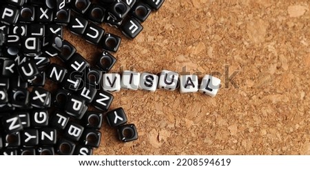 Visual word of plastic cube concept on wooden background.