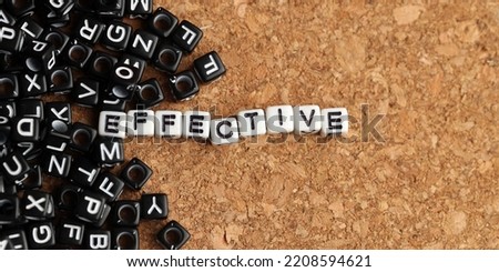 Effective word of plastic cube concept on wooden background.