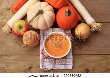 Homemade pumpkin soup on wood background