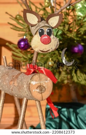 Homemede figure of Christmas deer made of wood and fabric. Selective focus. 