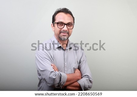 Portrait of a middle aged happy man of Indian origin Royalty-Free Stock Photo #2208650569