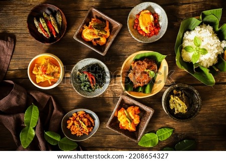 Nasi Padang. Padangnese meal of rice with various side dishes from Padang, West Sumatra. Royalty-Free Stock Photo #2208654327