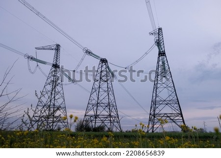 High voltage post or High voltage tower in the field. High voltage towers with sky background. A high voltage power pylons in Ukraine Royalty-Free Stock Photo #2208656839