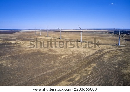 wind power plant in the steppe against the blue sky shooting from a drone. High quality photo