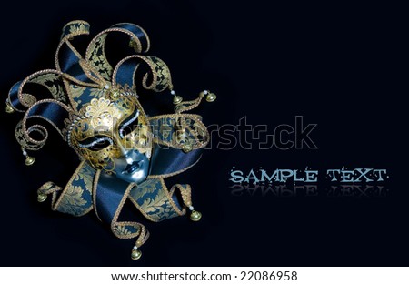 Ornate venetian mask lying on black background