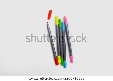 Set of multicolored felt-tip pens side by side, rainbow on a light white banner background. Drawing pens, pencils, artist tools, creativity, fun, hobby. Colorful school supplie Royalty-Free Stock Photo #2208718383