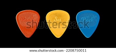 Guitar picks with the caption "Ready Set Rock". isolated on black. Royalty-Free Stock Photo #2208750011