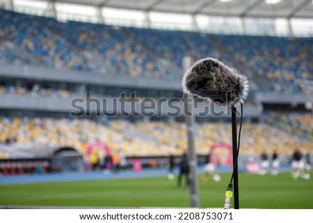 Directional microphone on the football field to record the sound of the match. High quality photo