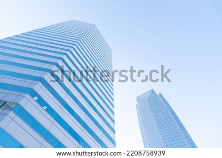 Lookup of skyscraper and cooperate office buildings in downtown Oklahoma City, USA under clear blue sky. Low angle view façade exterior of modern high rise towers