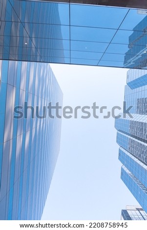 Lookup of skyscraper and cooperate office buildings in downtown Oklahoma City, USA under clear blue sky. Low angle view façade exterior of modern high rise towers