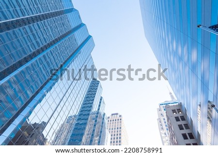 Reflection of skyscraper and cooperate office buildings on glass walls in downtown Oklahoma City, USA clear blue sky. Low angle view façade exterior of modern high rise towers