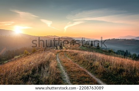 Impressive Nature Landscape. Amazing countryside landscape with valley in fog behind the grassy hills. Picture of wild area. Awesome nature Background. Carpathian mountains. Ukraine