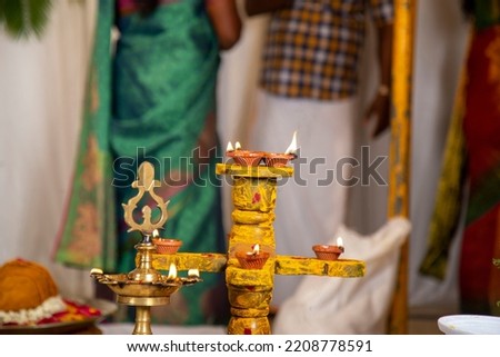 Tamil wedding stage. South Indian
traditional pooja lamb (vilaku) with wedding background.