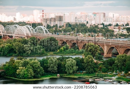 Amazing aerial drone view of the city river and bridges in Kyiv at sunset
