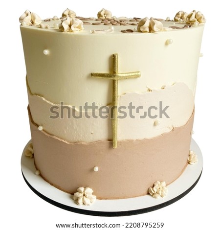 Cake for religious celebrations with a golden cross in front of the cake, on a white plate, isolated on a white background. Front view.