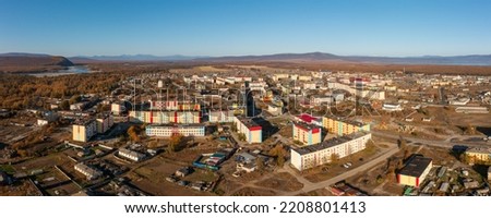 Aerial view of the northern urban-type settlement of Ola. Top view of painted multi-colored buildings. Ola is the administrative center of the Olsky district of the Magadan region. Siberia, Russia. Royalty-Free Stock Photo #2208801413