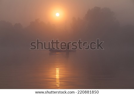 Young man canoeing in Canada at dawn