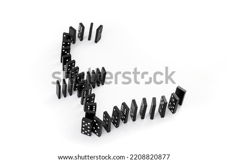 United kingdom currency symbol made from arranged black domino tiles on white background 
