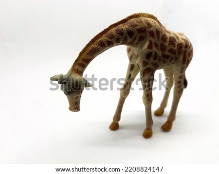 children's toys in the form of giraffes of different sizes and different poses. This toy is a figure. photographed on a white background. The texture and detail of the giraffe is meticulous. The color