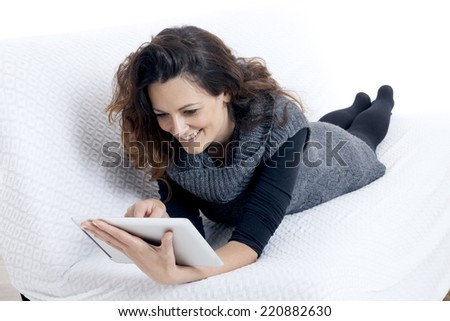 woman with laptop on white sheet in her bed at home