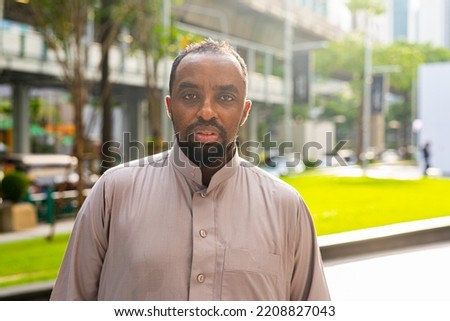 Portrait of black man in city wearing traditional clothes