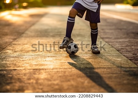 A teenager was playing football outdoors
