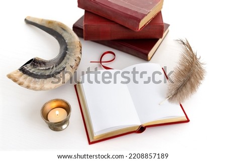 Shofar (horn), book and feather pen. Jewish holiday of Yom Kippur - day of fasting, repentance and remission of sins Royalty-Free Stock Photo #2208857189
