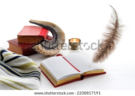 Shofar (horn), book and feather pen. Jewish holiday of Yom Kippur - day of fasting, repentance and remission of sins Royalty-Free Stock Photo #2208857191