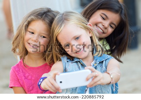 Portrait of group of childrens taking a selfie in the park.