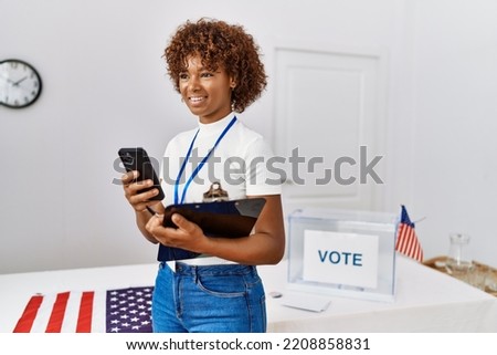Young african american woman smiling confident using smarpthone at electoral college
