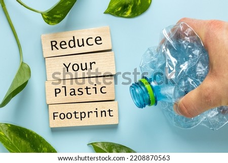 Hand crushing plastic bottle, Wooden block saved, Reduce Your plastic footprint, Environmental concept, Recycle plastic waste, reduce plastic production Royalty-Free Stock Photo #2208870563