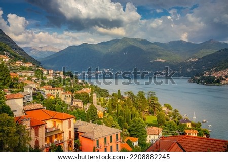 Idyllic Lake Como coastline with village and boat at dramatic sunset, Northern Italy Royalty-Free Stock Photo #2208882245
