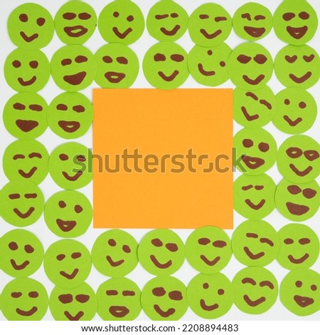 Creative flat lay layout made of paper faces and sticker about being surrounded by good positive people with smiles